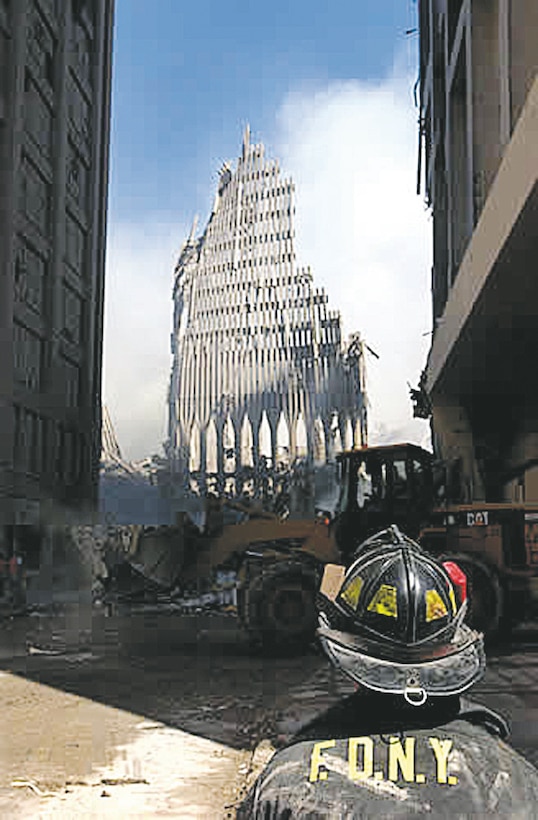 A New York City firefighter looks up at what remains of the World Trade Center Sept. 13, 2001, after its collapse following the Sept. 11, terrorist attack. 