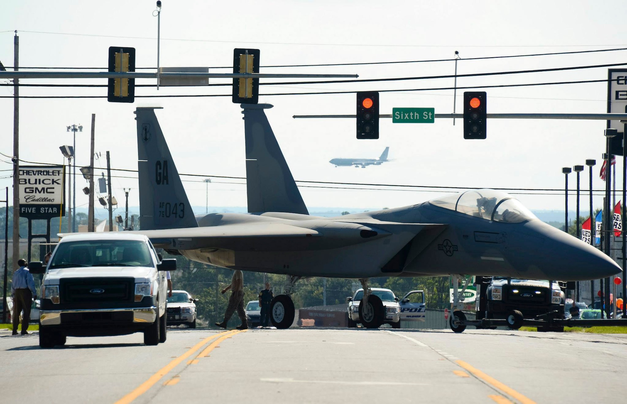 Airmen maneuver through traffic lights while towing an F-15 Eagle down Watson Boulevard to the Warner Robins City Hall, Warner Robins, Ga. Sept. 6, 2014. The aircraft was loaned to the city by the Georgia Air National Guard’s 116th Air Control Wing to serve as a static display for a new veteran’s memorial. The Airmen moving the aircraft are assigned to the 116th Maintenance Group. (U.S. Air National Guard photo/Tech. Sgt. Regina Young)   