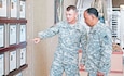 Maj. Gen. Paul E. Funk II, commanding general, 1st Inf. Div. and Fort Riley, shows Gen. Dennis L. Via, commander, USAMC, a display of “Big Red One” Medal of Honor recipients in the entryway of the division’s headquarters building Aug. 14 at Fort Riley.  