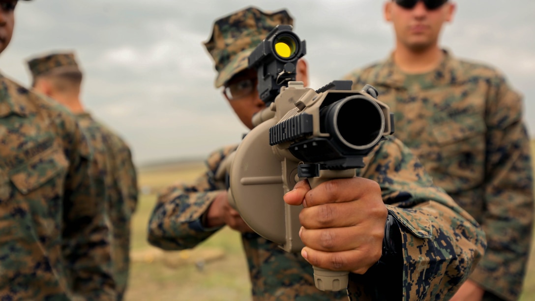 A Marine with Black Sea Rotational Force 14 sights in on a target using the M32 Multiple Grenade Launcher Sept. 8, during a non-lethal weapons range near Mihail Kogalniceanu Air Base, Romania. The current iteration of BSRF-14 will conduct non-lethal weapons training with Eastern European security partners during their six-month rotation.