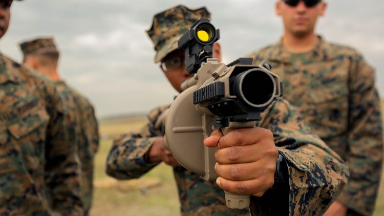 A Marine with Black Sea Rotational Force 14 sights in on a target using the M32 Multiple Grenade Launcher Sept. 8, during a non-lethal weapons range near Mihail Kogalniceanu Air Base, Romania. The current iteration of BSRF-14 will conduct non-lethal weapons training with Eastern European security partners during their six-month rotation.