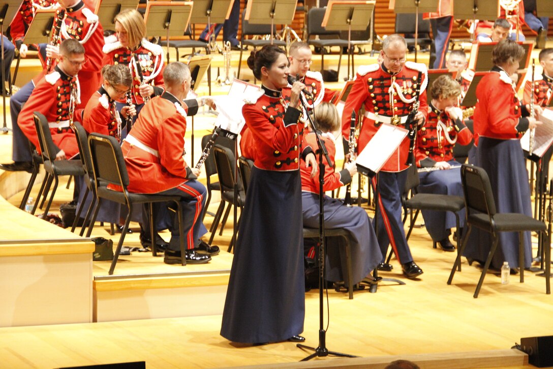 Gunnery Sgt. Sara Dell'Omo, a United States Marine Band mezzo-soprano vocalist, addresses those in attendance in Helzberg Hall at the Kauffman Center for the Performing Arts in Kansas City, Mo., during the The President's Own's 2014 National Tour Sept. 10, 2014. The band performed a number of songs from both traiditonal and military styled compositions throughout the performance such as John Philip Sousa's "Semper Fidelis", "The Stars and Stripes Forever," and "Solid Men to the Front". 