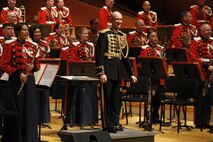 Lieutenant Col. Jason K. Fettig, the United States Marine Band director, smiles on behalf of the band to the crowd while receivng applause  in Helzberg Hall at the Kauffman Center for the Performing Arts in Kansas City, Mo., Sept. 10, 2014. The band's tour stretches from Maryland to Washington State and started on Sept. 1 and is slated to conclude Sept. 29.