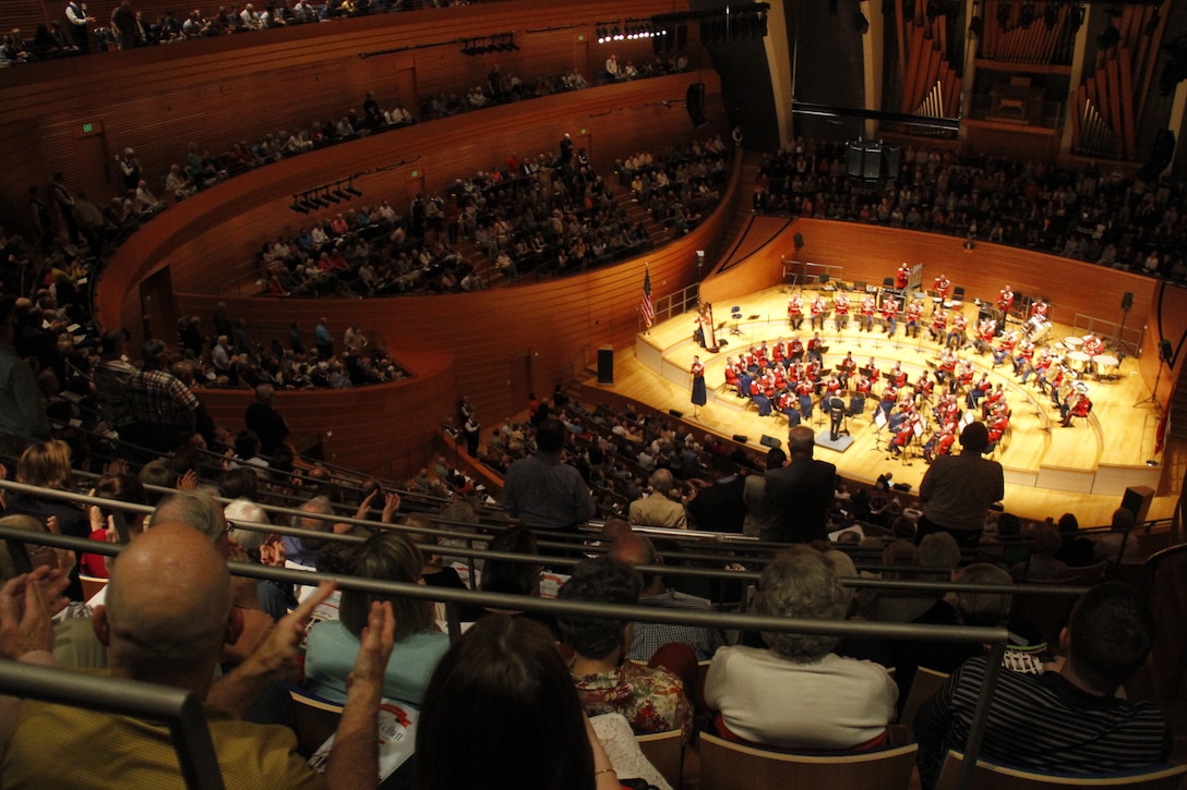 Audience members clap and stand as the United States Marine Band performs the official songs of all the United States armed forces to close out the evening's events in Helzberg Hall at the Kauffman Center for the Performing Arts in Kansas City, Mo., Sept. 10, 2014. 