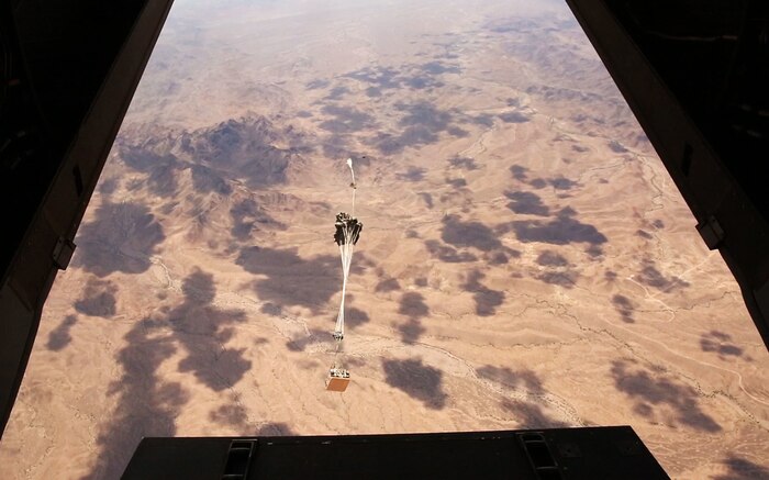 A Joint Precision Airdrop System drops from an MV-22 Osprey during testing of the system Aug. 26, 2014, at Yuma Proving Ground, Ariz. The JPADS systems use GPS, a modular autonomous guidance unit, or MAGU, a parachute and electric motors to guide cargo within 150 meters of their target points. To test its precision, the Marines used a series of palletized loads attached to parachutes with the GPS integrated system and dropped them from various heights. (U.S. Marine Corps photo by Sgt. Laura Gauna/ released)