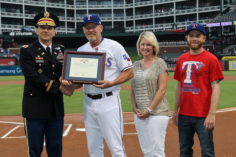 Texas Rangers bench coach Bobby Jones receives the citation for the Bronze Star Medal, awarded for his service in Vietnam.  Presenting the award was Col. Richard J. Muraski Jr., deputy commander of the   Southwestern Division, U. S. Army Corps of Engineers.  