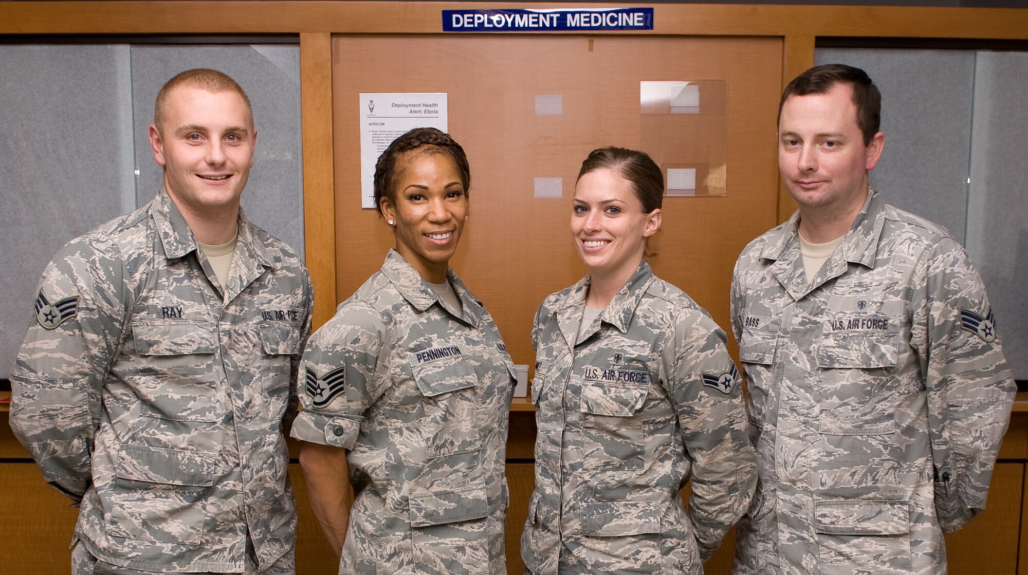 1st Special Operations Aerospace Medical Squadron Deployment Medicine Section Airmen, left to right, Senior Airman Ethan Ray, Staff Sgt. Evon Pennington, Airman 1st Class Susan Janks, Senior Airman Eric Bass, with take a group photo at the Hurlburt Field Clinic on Sept. 10, 2014. Airmen and their families can walk-in to the deployment health section to receive health information about their travel destination by medical experts without having to see their primary care provider. (U.S. Air Force photo/Senior Airman Kentavist P. Brackin) 