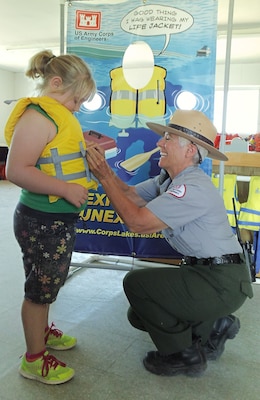 CONCHAS DAM, N.M. -- Park Ranger Valerie Mavis adjusts a girl's life jacket to ensure a proper fit, Aug. 31, 2014.