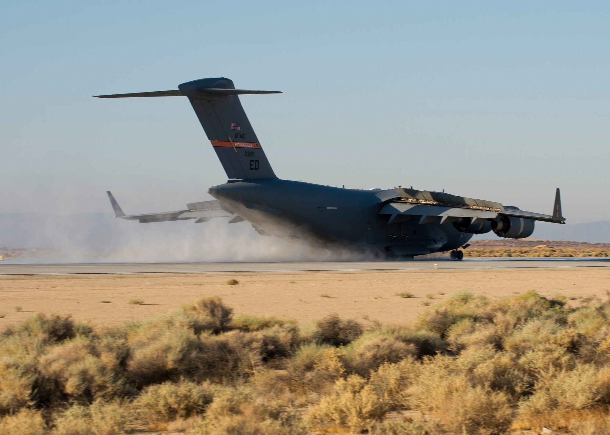 A C-17 Globemaster III performs a wet-runway performance test Aug. 20, 2014, on the flightline at Edwards Air Force Base, Calif. Since Dunlop Tire was selected as the replacement tire for the Globemaster III, the C-17 Global Reach Integrated Test Team at Edwards AFB has been putting the C-17’s new Dunlop tires through wet-and-dry runway takeoff and landing performance tests. (U.S. Air Force photo/ Ethan Wagner)