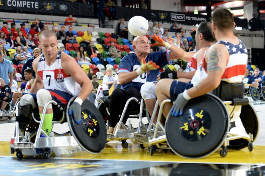Three American defenders knock the ball away from an Australian player during a wheelchair rugby match Sept. 12, 2014, at the 2014 Invictus Games in London. The U.S. won the match 14-4. Invictus Games is an international competition that brings together wounded, injured and ill service members in the spirit of friendly athletic competition. American Soldiers, Sailors, Airmen and Marines are representing the U.S. in the competition which is taking place Sept. 10-14. (U.S. Navy photo/Mass Communication Specialist 2nd Class Joshua D. Sheppard)