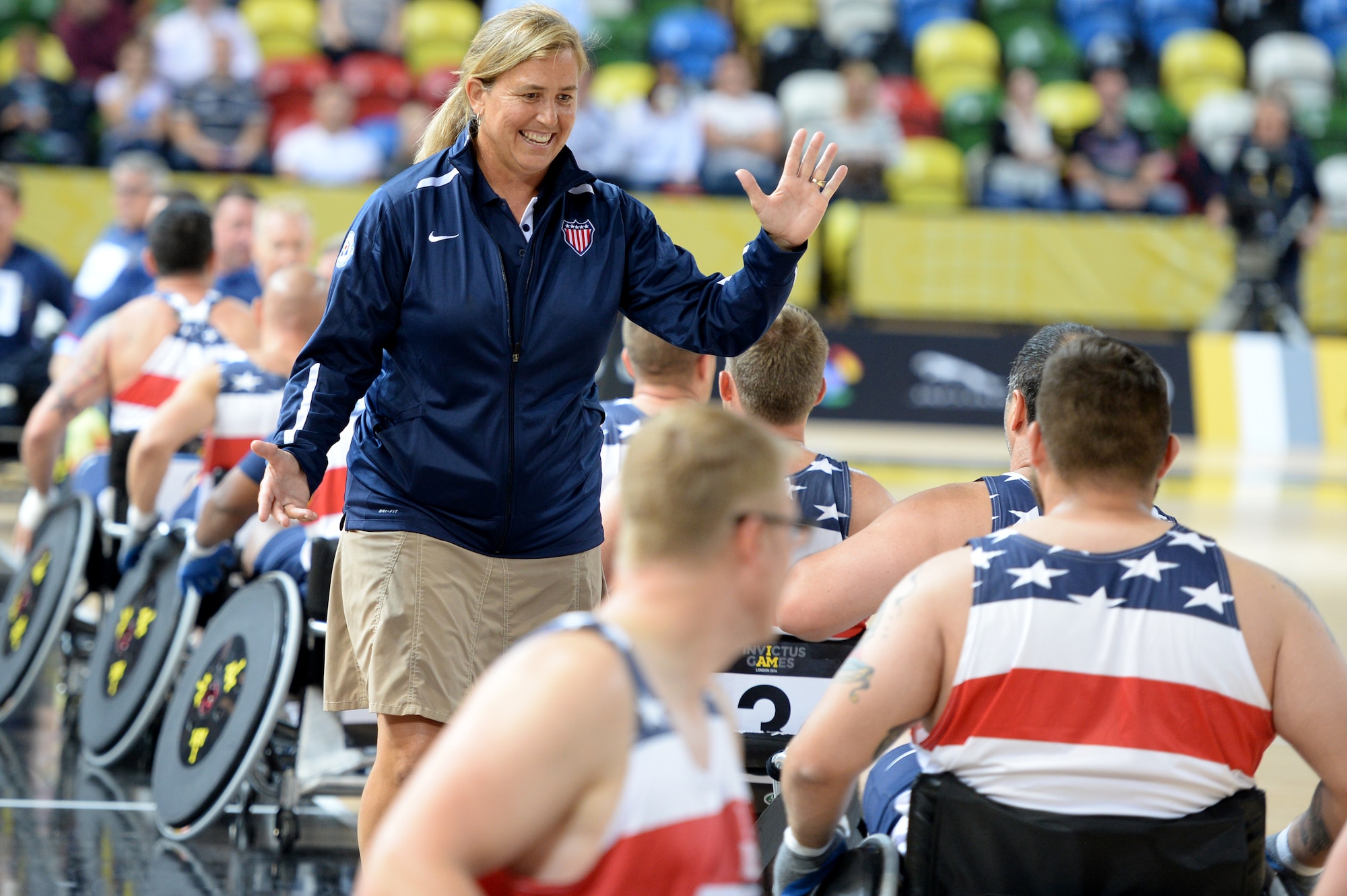 The American wheelchair rugby coach congratulates her team after their 14-4 victory over Australia in a wheelchair rugby match Sept. 12, 2014, at the 2014 Invictus Games in London. Invictus Games is an international competition that brings together wounded, injured and ill service members in the spirit of friendly athletic competition. American Soldiers, Sailors, Airmen and Marines are representing the U.S. in the competition which is taking place Sept. 10-14. (U.S. Navy photo/Mass Communication Specialist 2nd Class Joshua D. Sheppard)