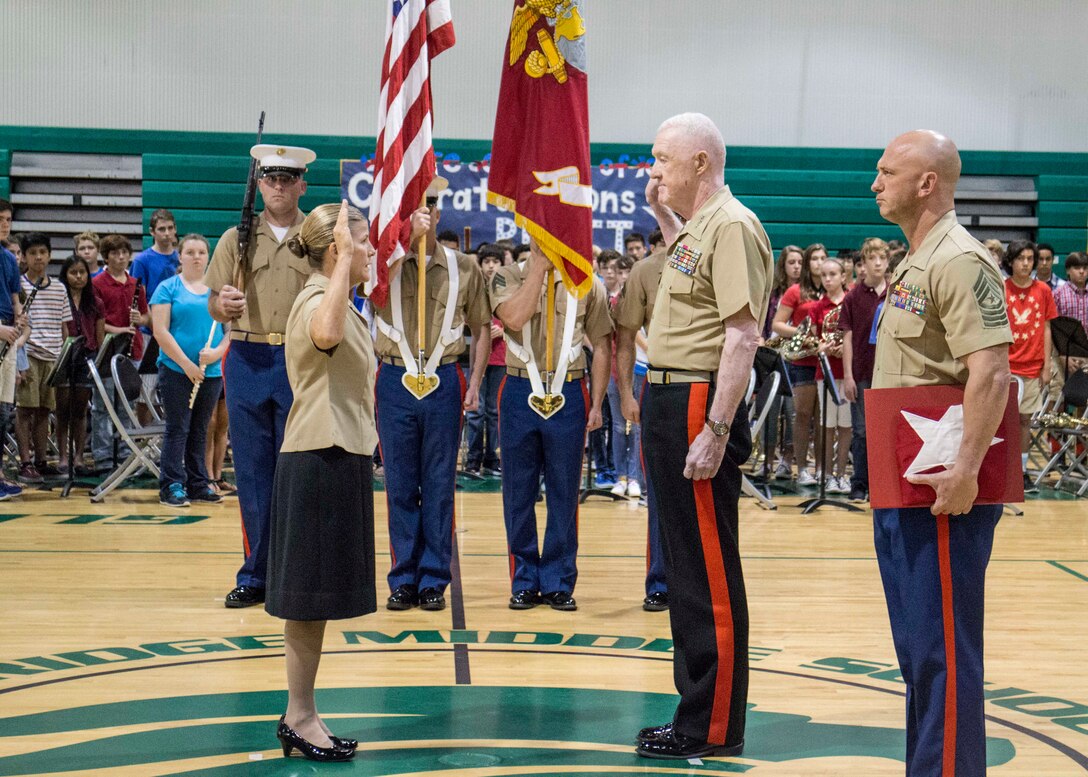 Brig. Gen. Helen G. Pratt (left), commanding general of Force Headquarters Group, repeats the oath of office to Lt. Gen. Richard Mills, commander of Marine Forces Reserve, during her promotion ceremony at Glenridge Middle School Sept. 5, 2014. Assisting Mills is Sgt. Maj. Michael E. Sprague, sergeant major of FHG. Pratt was promoted in front of the students, teachers and fellow staff members of the school, where she was a guidance counselor prior to taking command.