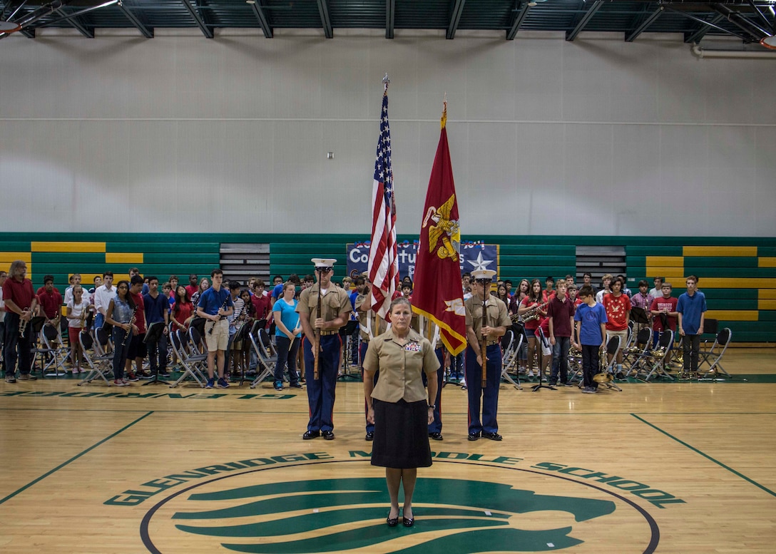 Brig. Gen. Helen G. Pratt, commanding general of Force Headquarters Group, stands at the position of attention as honors are rendered at her promotion ceremony at Glenridge Middle School Sept. 5, 2014. Pratt was promoted in front of the students, teachers and fellow staff members of the school, where she was a guidance counselor prior to taking command.