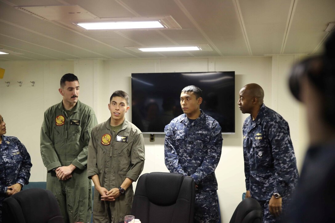 Lance Cpl. Christian Chevez, MV-22 crew chief with Marine Operational Test and Evaluation Squadron 22, and a native of Dallas, Texas, speaks to distinguished visitors from El Salvador about his ties with the country during a key leader engagement (KLE) aboard the future amphibious assault ship USS America (LHA 6), Sept. 8, 2014. The KLE consisted of a tour, a formal lunch and a leadership conference discussing the importance of partnership and cooperation between the U.S Naval forces and the Nation of El Salvador. Marines and Sailors with Special Purpose Marine Air Ground Task Force South are embarked aboard America in support of her maiden transit, “America Visits the Americas.” The transit demonstrates the unparalleled capabilities that the Navy-Marine Corps team brings to our Nation and partners. (U.S. Marine Corps photo by 1st Lt. Joshua Pena / Released)