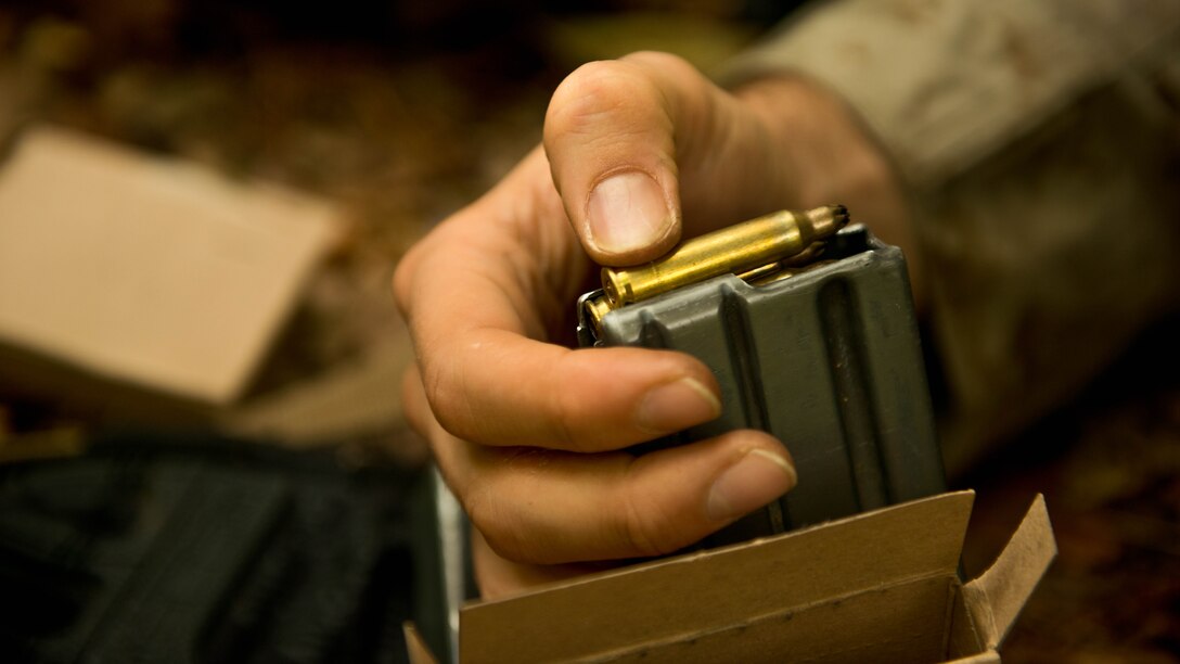 A student with Charlie Company at The Basic School at Marine Corps Base Quantico, loads his magazine Sept. 8 at the training grounds of Quantico. The Marines are on their seven-day War Field Exercise from Sept. 5-12.