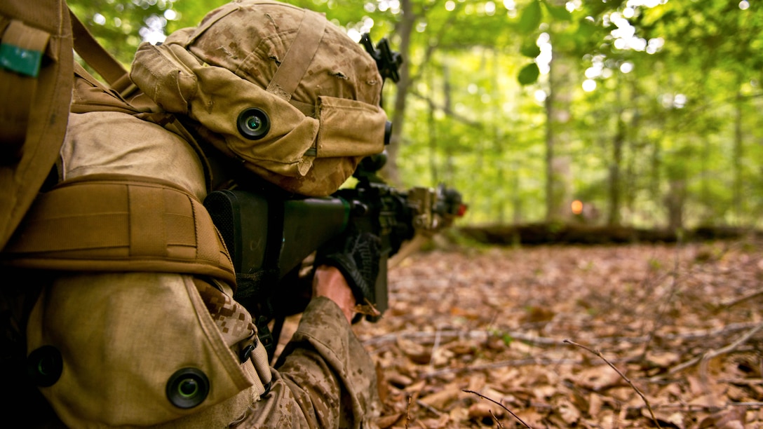 2nd Lt. Douglas M. Bour, a student with Charlie Company at The Basic School at Marine Corps Base Quantico, fires blank rounds at the mock enemy in a simulated combat scenario Sept. 9 at the training grounds of Quantico. The Marines are on their seven-day War Field Exercise from Sept. 5-12. 