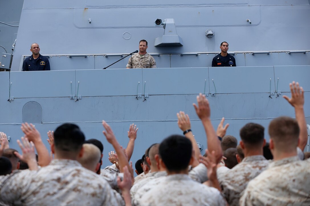 Lt. Col. Eddy I. Hansen, center, executive officer of the 11th Marine Expeditionary Unit, addresses Marines and sailors aboard the USS San Diego during a remembrance ceremony honoring the victims of the attacks of Sept. 11, 2001 and those who have since served in defense of the nation. The 11th MEU and Makin Island Amphibious Ready Group are deployed to the U.S. 7th Fleet area of operations as a sea-based, expeditionary crisis response force capable of conducting amphibious missions across the full range of military operations. (U.S. Marine Corps photo by Gunnery Sgt. Rome M. Lazarus/Released)