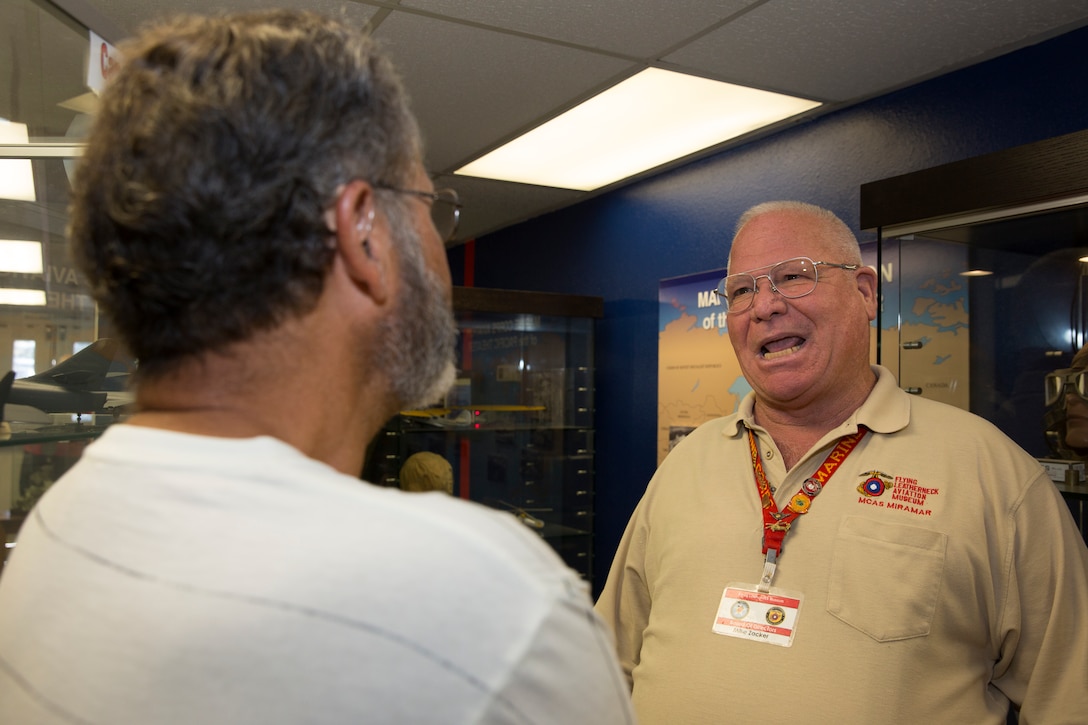 Retired Sgt. Maj. Mike Zacker, secretary of the board of directors and docent at the Flying Leatherneck Aviation Museum and Historical Foundation, speaks with a guest at the museum aboard Marine Corps Air Station Miramar, Calif., Sept. 10. When Service members visit the museum Zacker likes to talk about some of the ways Marine Corps aviation has changed since he served in the Vietnam War.