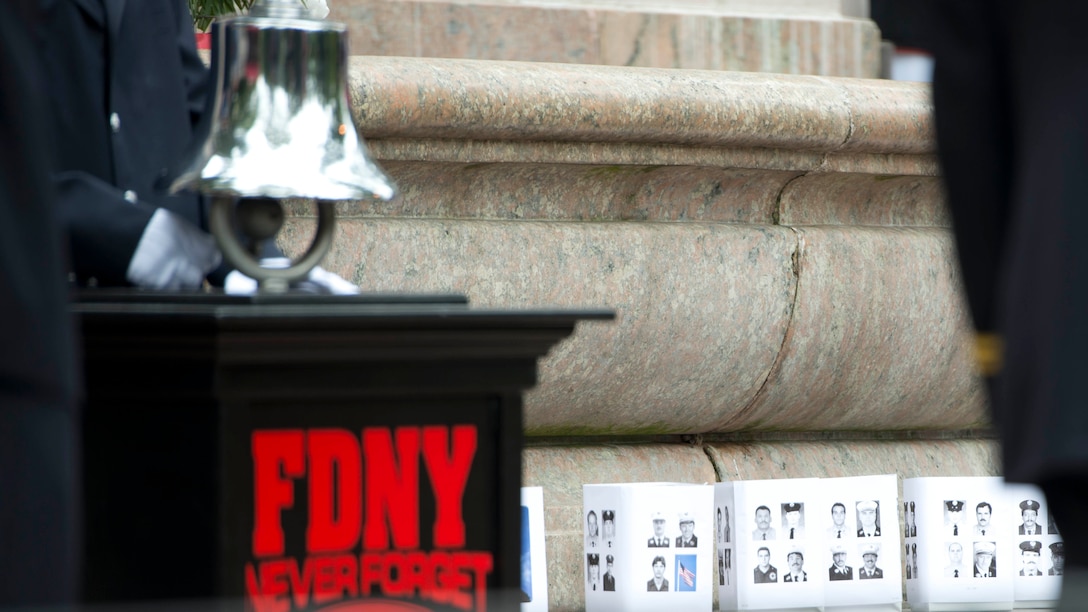 Photos of fallen firefighters are displayed during the New York City Fire Department’s commemoration ceremony Sept. 11, 2014. The Quantico Marine Band traveled to the city to perform and pay their respects to the people, who lost their lives 13 years ago during the 9/11 attacks on the World Trade Center.