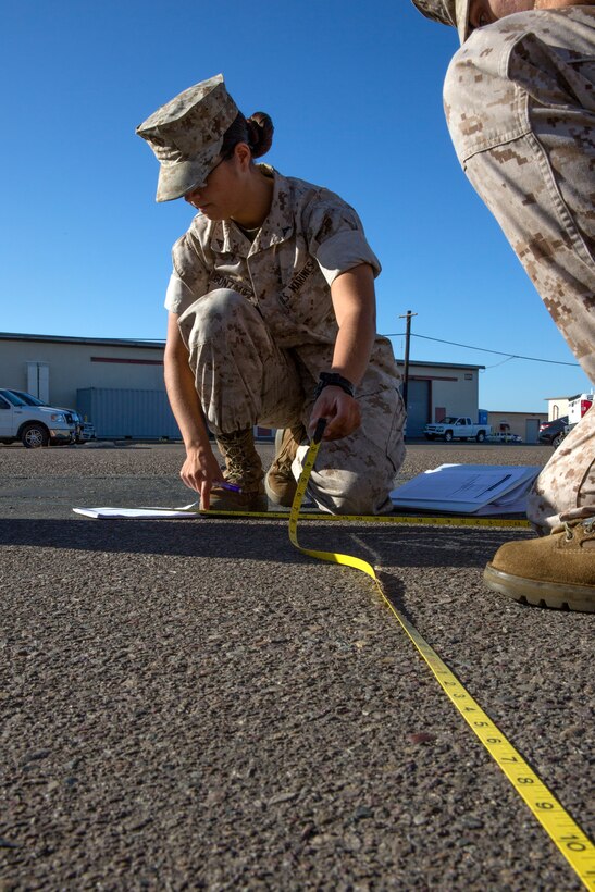 Lance Cpl. Karen Gonzalez, a military police officer with 1st Law Enforcement Battalion, I Marine Expeditionary Force, looks over her notes during the Traffic Collision Investigation Course aboard Marine Corps Air Station Miramar, Calif., Sept. 11. The 17-day course equates to 136 hours of class time and seven college credits students receive upon completion of the course. The class is scheduled to graduate and receive their certifications on Sept. 30.