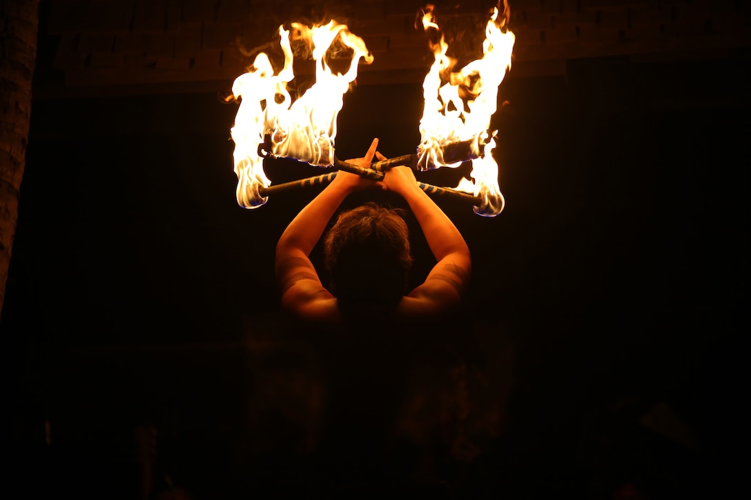 KAPOLEI, Hawaii - A Samoan fire-knife dancer at Germaine’s Luau in Kapolei, Hawaii, awes the crowd with his performance at the luau Sept. 6, 2014. Originally performed with sharp blades, the dancer now uses burning torches. (U.S. Marine Corps photo by Pfc. Harley Thomas)