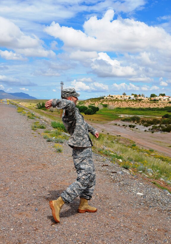 LAS CRUCES, N.M., -- District Commander Lt. Col. Patrick Dagon throws a seed ball as part of the ribbon cutting ceremony for the $1.6 million environmental restoration project near the Las Cruces Dam, Sept. 5, 2014. The seed balls are packed with a mixture of wildflower seeds that "are waiting for nature to release with steady rain," said Lisa LaRocque, city of Las Cruces sustainability officer. 