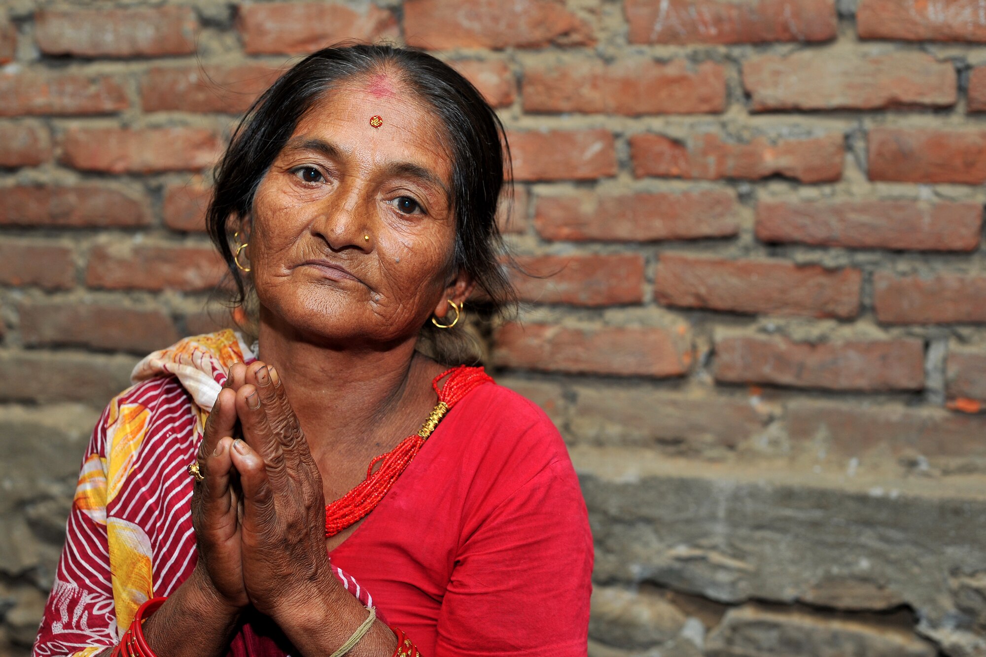 A patient waits to be seen by Operation Pacific Angel-Nepal physical therapists at a health services outreach site in Shaktikhor, Nepal, Sept. 12, 2014. PACANGEL helps cultivate common bonds and foster goodwill between the U.S., Nepal and regional nations by conducting multilateral humanitarian assistance and civil military operations. (U.S. Air Force photo by Staff Sgt. Melissa B. White/Released)