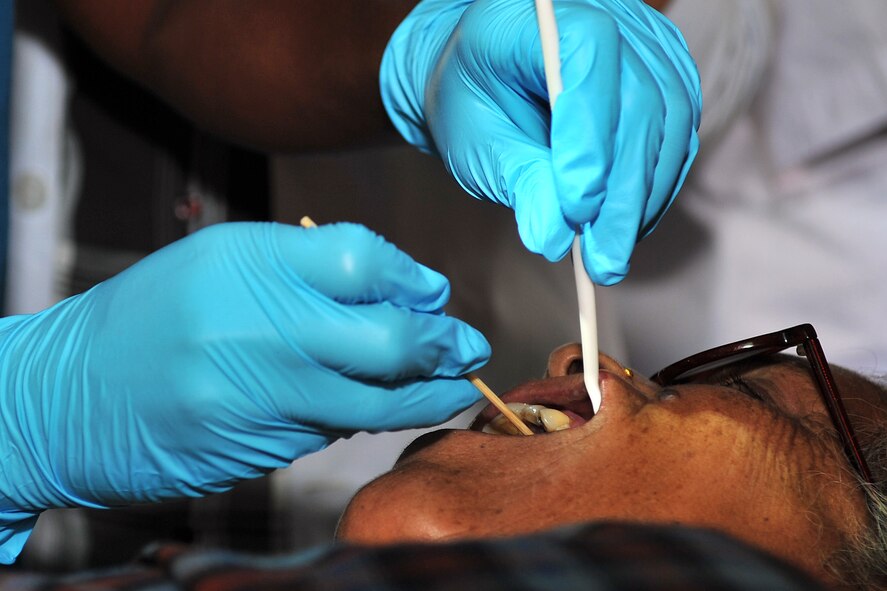 U.S. Navy Lt. Erin Bailey, Operation Pacific Angel-Nepal dentist, applies a local anesthetic to a patient’s mouth at a health services outreach site in Shaktikhor, Nepal, Sept. 12, 2014. PACANGEL supports U.S. Pacific Command’s capacity-building efforts by partnering with other governments, non-governmental agencies and multilateral militaries in the respective region to provide medical, dental, optometry and engineering assistance to their citizens. (U.S. Air Force photo by Staff Sgt. Melissa B. White/Released)