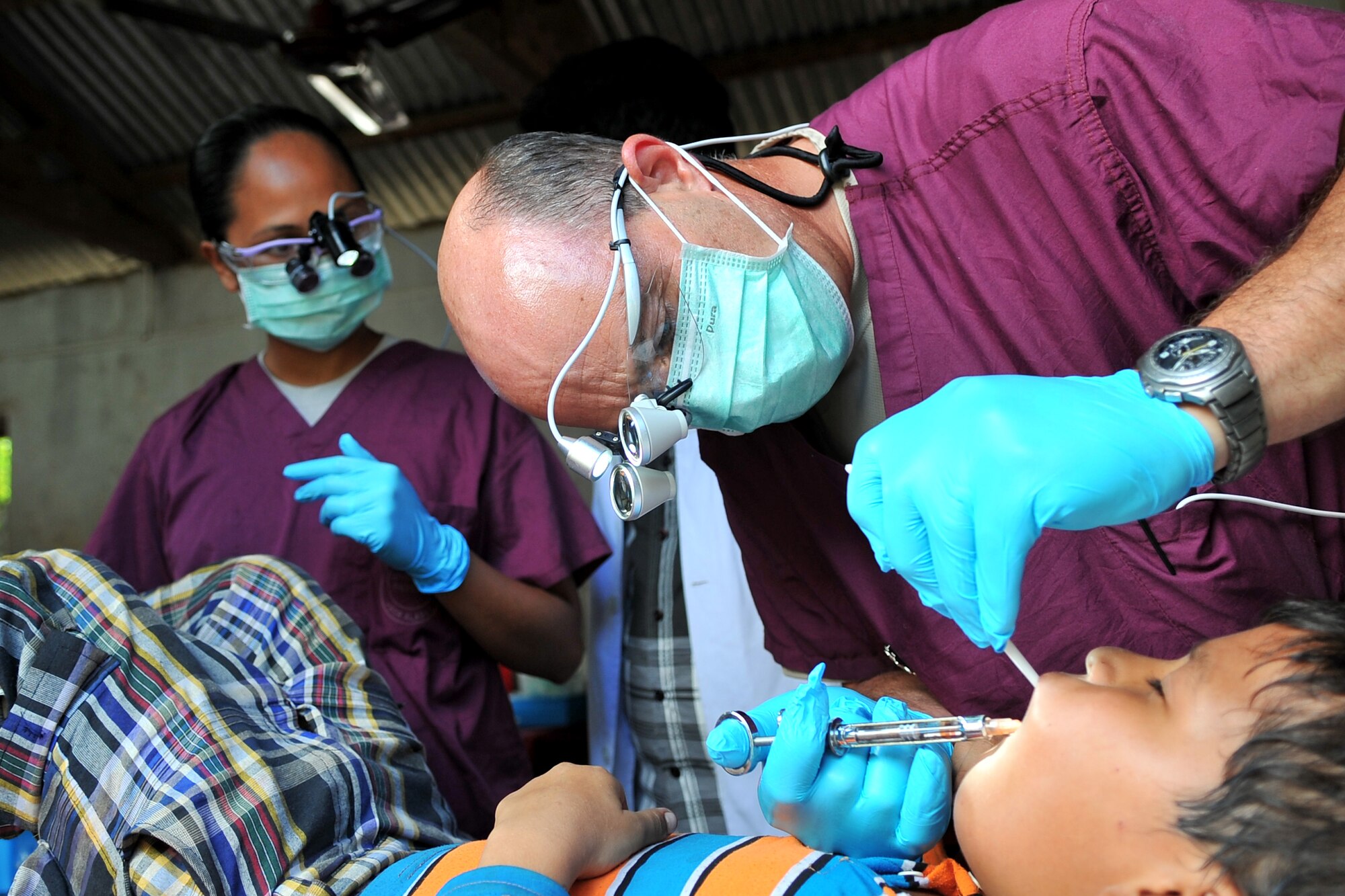 U.S. Air Force Lt. Col. (Dr.) William Hammer, Operation Pacific Angel-Nepal dentist, applies a local anesthetic to a patient’s mouth at a health services outreach site in Shaktikhor, Nepal, Sept. 12, 2014. PACANGEL supports U.S. Pacific Command’s capacity-building efforts by partnering with other governments, non-governmental agencies and multilateral militaries in the respective region to provide medical, dental, optometry and engineering assistance to their citizens. (U.S. Air Force photo by Staff Sgt. Melissa B. White/Released)