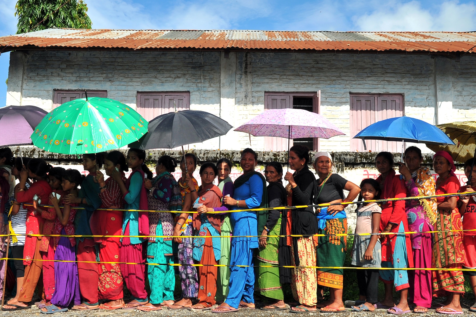 Nepalese women and children wait outside the gate to be seen by Operation Pacific Angel-Nepal medical providers at a health services outreach site in Shaktikhor, Nepal, Sept. 12, 2014. PACANGEL supports U.S. Pacific Command’s capacity-building efforts by partnering with other governments, non-governmental agencies and multilateral militaries in the respective region to provide medical, dental, optometry and engineering assistance to their citizens. (U.S. Air Force photo by Staff Sgt. Melissa B. White/Released)