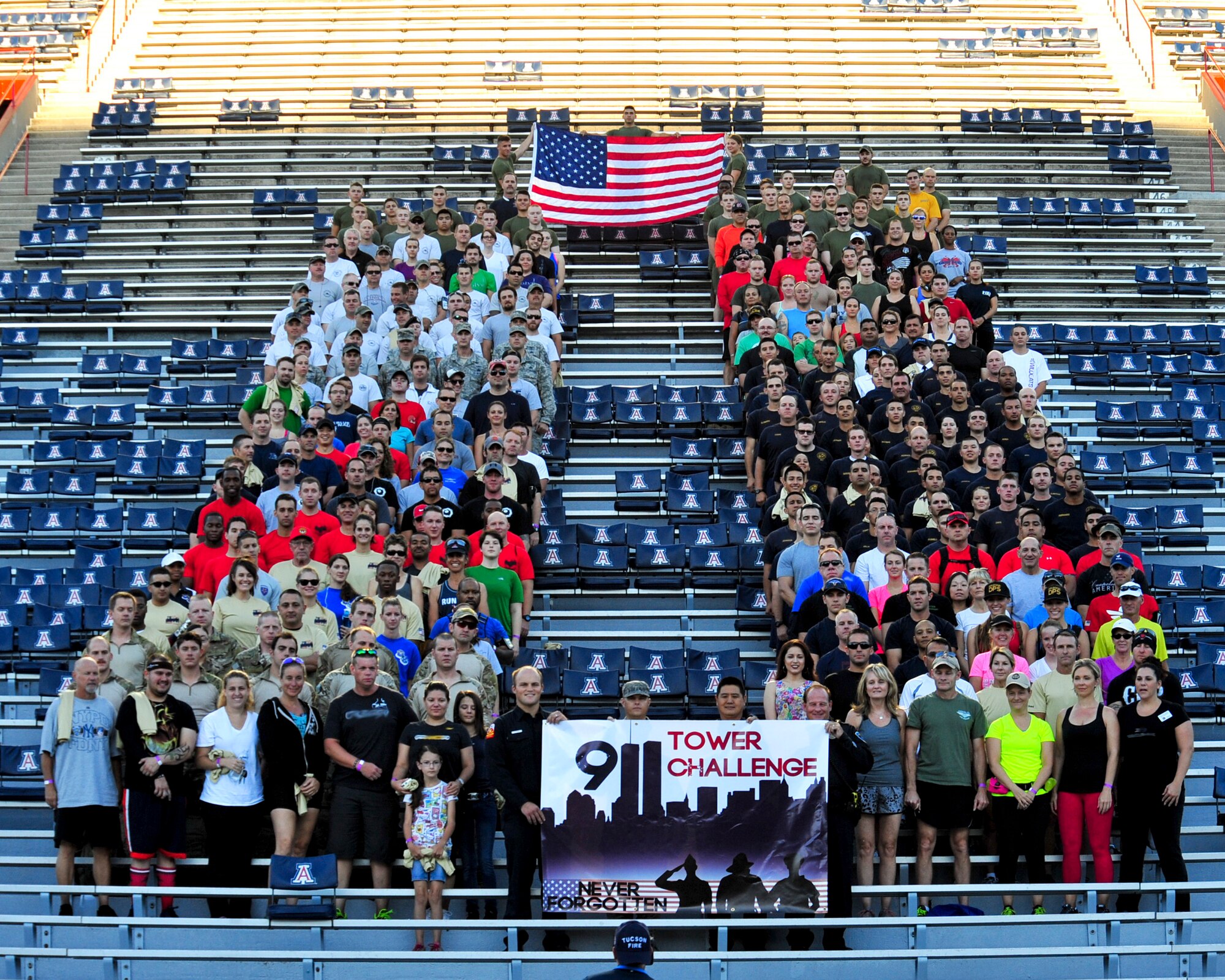 Participants of the Never Forgotten 9/11 Tower Challenge pose for a group photo at the University of Arizona Football Stadium, Tucson, Ariz., Sept. 11, 2014.  Approximately 350 participants took on the challenge the climbing 2,071 stairs, symbolizing the 110 floors of each Twin Tower of the World Trade Center.  (U.S. Air Force Photo by Airman 1st Class Chris Massey)