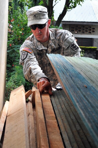 U.S. Army Staff Sgt. Adam Isdale, Operation Pacific Angel-Nepal structural NCO, retrieves wood for an engineering civic action project in Shaktikhor, Nepal, Sept. 10, 2014. PACANGEL supports U.S. Pacific Command’s capacity-building efforts by partnering with other governments, non-governmental agencies and multilateral militaries in the respective region to provide medical, dental, optometry and engineering assistance to their citizens. (U.S. Air Force photo by Staff Sgt. Melissa B. White/Released)