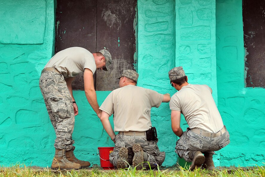 U.S. Air Force Airmen paint the outside of a school as part of an Operation Pacific Angel-Nepal Engineering Civic Action Project in Shaktikhor, Nepal, Sept. 11, 2014. PACANGEL helps cultivate common bonds and foster goodwill between the U.S., Nepal and regional nations by conducting multilateral humanitarian assistance and civil military operations. (U.S. Air Force photo by Staff Sgt. Melissa B. White/Released)