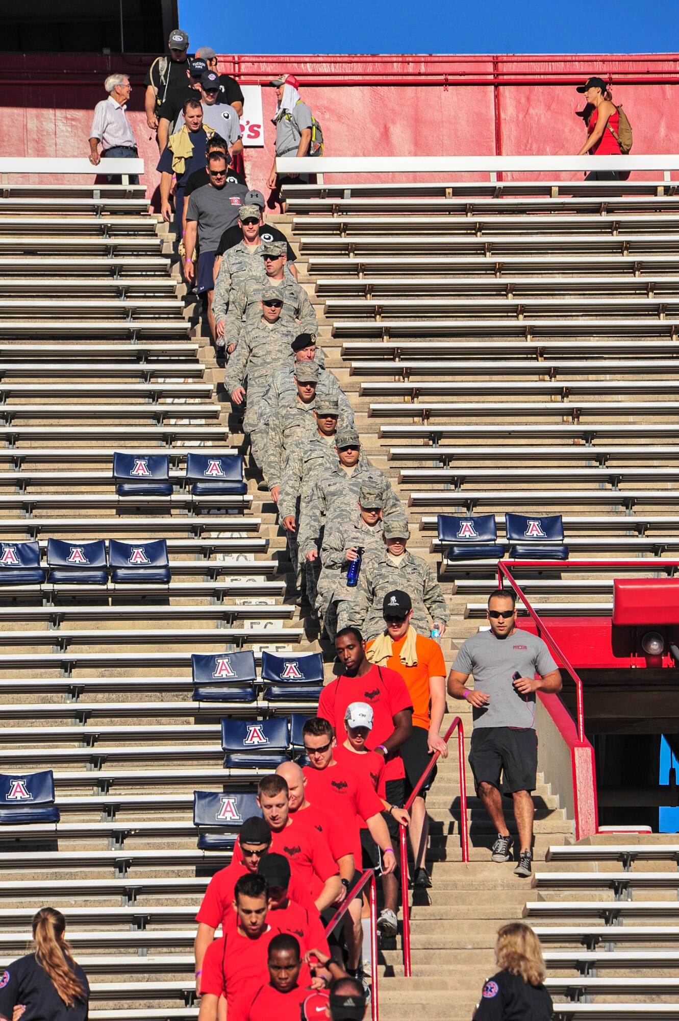 Members of the Davis-Monthan Air Force Base First Sergeants Council and 43rd Electronic Combat Squadron participate in the Never Forgotten 9/11 Tower Challenge at the University of Arizona Football Stadium, Tucson, Ariz., Sept. 11, 2014.  The event was hosted by the Greater Tucson Fire Foundation to honor those who lost their lives on 9/11 and the first responders and military who continue to protect the nation from foreign and domestic threats.  (U.S. Air Force Photo by Airman 1st Class Chris Massey)