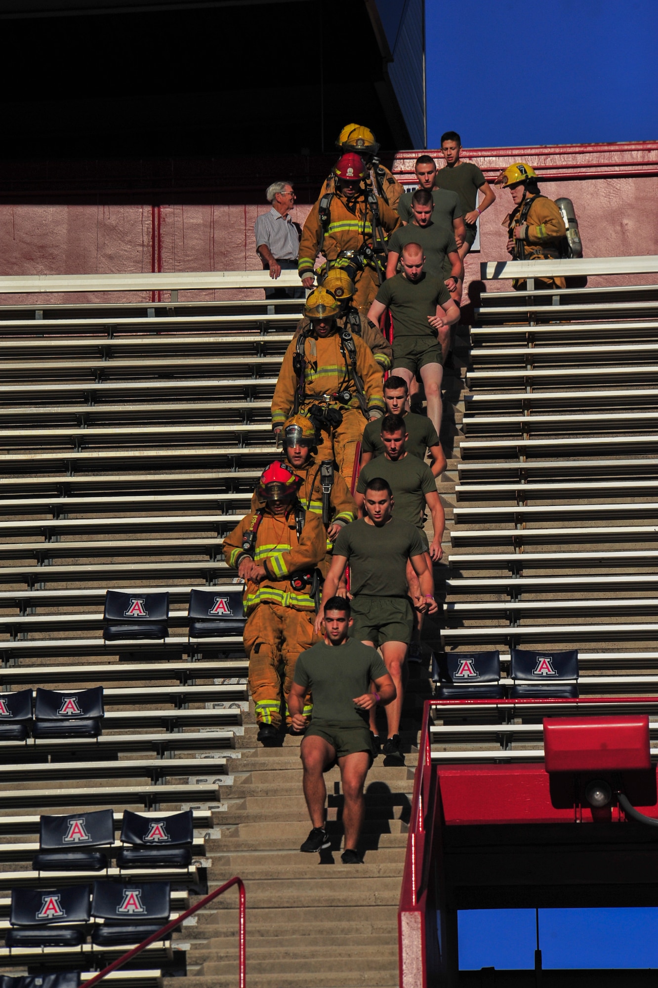 Members of the Tucson Fire Department and Marine Corps Naval Reserve Officers’ Training Corps cadets descend stairs during Never Forgotten 9/11 Tower Challenge at the University of Arizona Football Stadium, Tucson, Ariz., Sept. 11, 2014.  Approximately 350 participants attempted the challenge of climbing 2,071 stairs, symbolizing the 110 floors of each Twin Tower of the World Trade Center.  (U.S. Air Force Photo by Airman 1st Class Chris Massey)