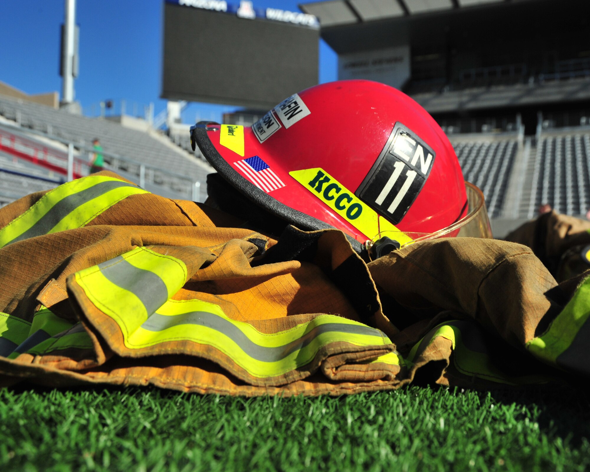Tucson Fire Department gear lies on the field after completion of the Never Forgotten 9/11 Tower Challenge held at the University of Arizona Football Stadium, Tucson, Ariz., Sept. 11, 2014.  The event was hosted by the Greater Tucson Fire Foundation to honor those who lost their lives on 9/11 and the first responders and military who continue to protect the nation from foreign and domestic threats.  (U.S. Air Force Photo by Airman 1st Class Chris Massey)