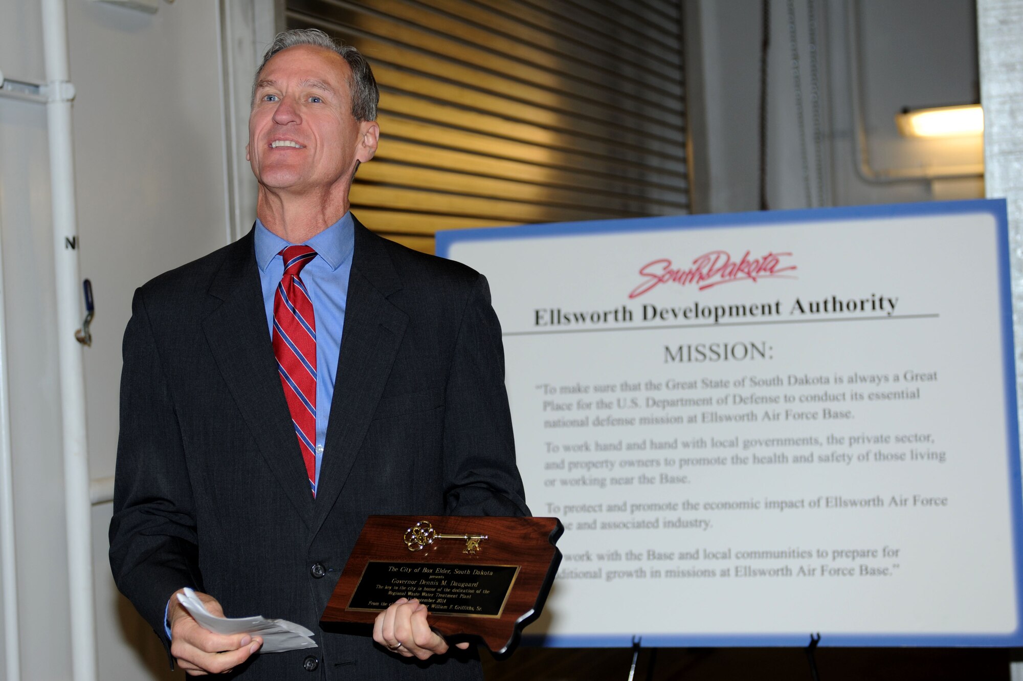 Dennis Daugaard, Governor of South Dakota, speaks at a ceremony for the opening of the Box Elder Regional Wastewater Treatment Facility in Box Elder, S.D., Sept. 11, 2014. The state-of-the-art treatment plant runs wastewater through a variety of systems to produce fresh water using ultraviolet light rather than chlorine during the final stage of treatment. (U.S. Air Force photo by Senior Airman Hailey R. Staker/Released)