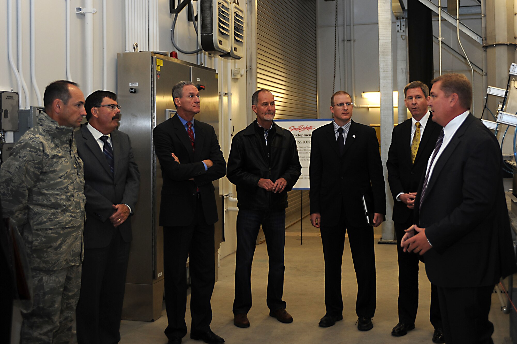 Scott Landguth, Ellsworth Development Authority executive director, (right) briefs local leaders at the Box Elder Regional Wastewater Treatment Facility in Box Elder, S.D., Sept. 11, 2014. The newly constructed facility supports Box Elder and Ellsworth, providing usable fresh water for both communities. (U.S. Air Force photo by Senior Airman Hailey R. Staker/Released)