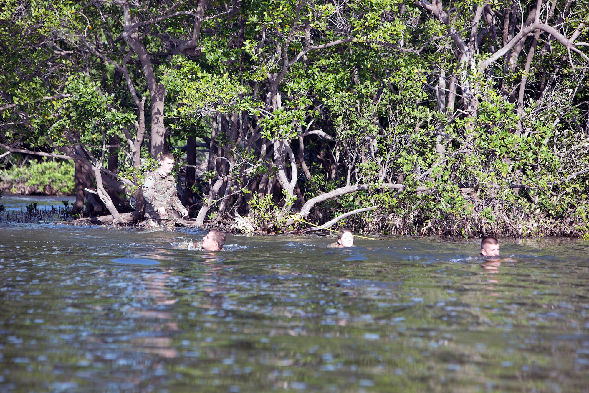 Senior Airman Jeffrey Gebhardt (right), 446th Force Support Squadron client systems technician, out of Joint Base Lewis-McChord, Washington, and his teammates swim through one of the numerous obstacles at Warrior Spirit, Aug. 18, 2014 at MacDill Air Force Base, Florida. Gebhardt has been assigned to the Joint Communications Support Element at MacDill since November 2013, and is on long-term orders to continue his needed support. Warrior Spirit is a weeklong team-based exercise built to validate technical and tactical skills while creating unit cohesion. (Courtesy photo/JCSE)