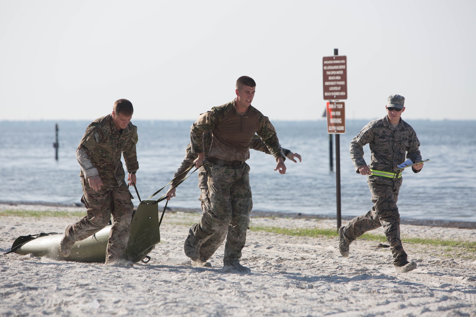 Senior Airman Jeffrey Gebhardt (center), 446th Force Support Squadron client systems technician, out of Joint Base Lewis-McChord, Washington, and his teammates haul through one of the numerous obstacles at Warrior Spirit, Aug. 18, 2014 at MacDill Air Force Base, Florida. Gebhardt has been assigned to the Joint Communications Support Element at MacDill since November 2013, and is on long-term orders to continue his needed support. Warrior Spirit is a weeklong team-based exercise built to validate technical and tactical skills while creating unit cohesion. (Courtesy photo/JCSE)