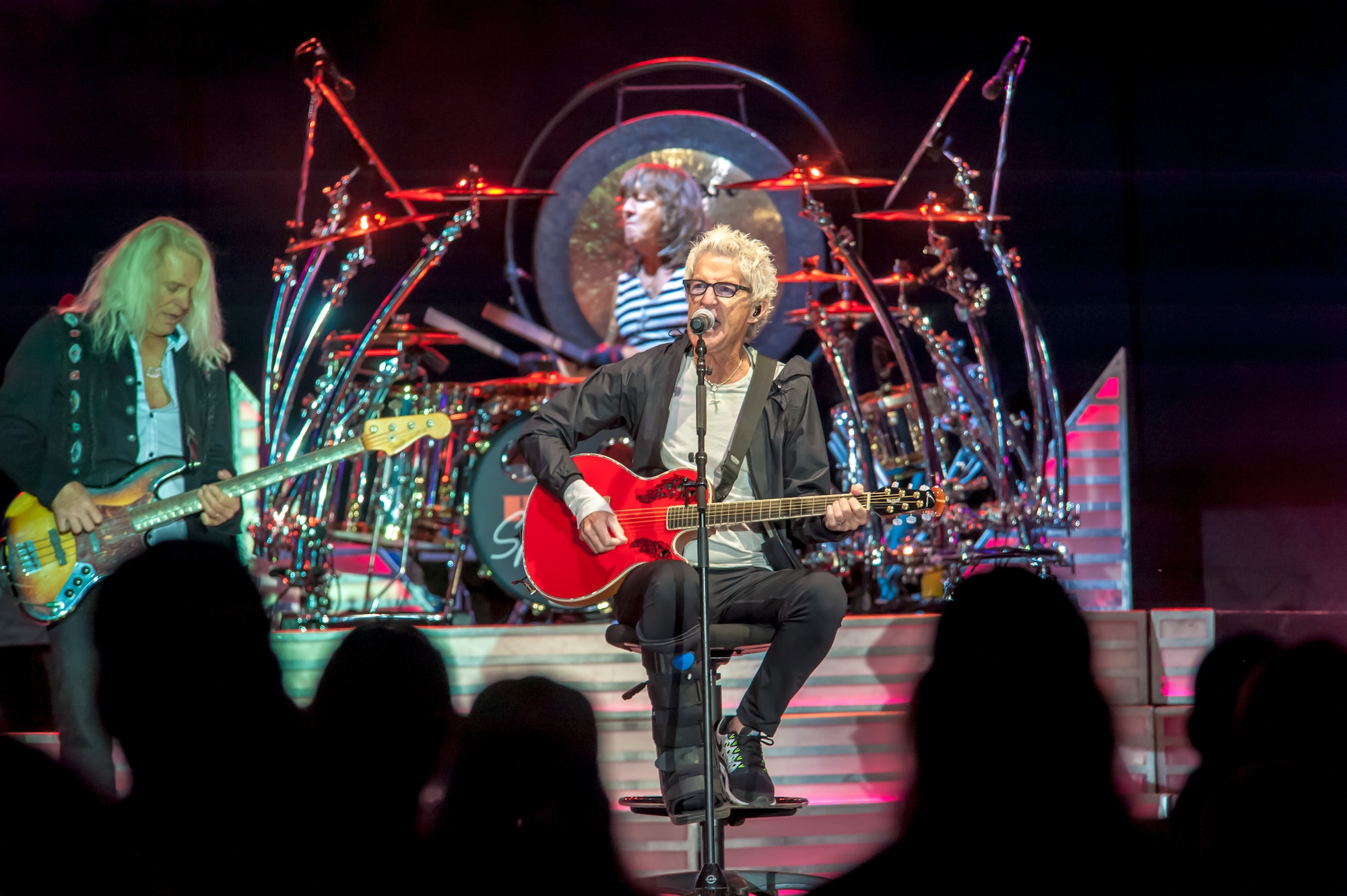 Kevin Cronin, the REO Speedwagon lead vocalist and rhythm guitarist, sings to an audience including America’s veterans as Bruce Hall, the band’s bass guitarist and harmony vocalist, and Bryan Hitt, REO’s percussion and drummer, keep the rhythm during a Grandstand performance at the Spokane Interstate Fair in Spokane, Washington, Sept. 11, 2014. REO Speedwagon thanked America’s veterans and families, both past and present, for their service and sacrifice in the name of freedom. Total force Airmen from around the globe took time to commemorate the 13th anniversary of Sept. 11, 2001, with everything from commemorative runs, to tributes and moments of silence. (U.S. Air Force photo by Staff Sgt. Benjamin W. Stratton/Released)