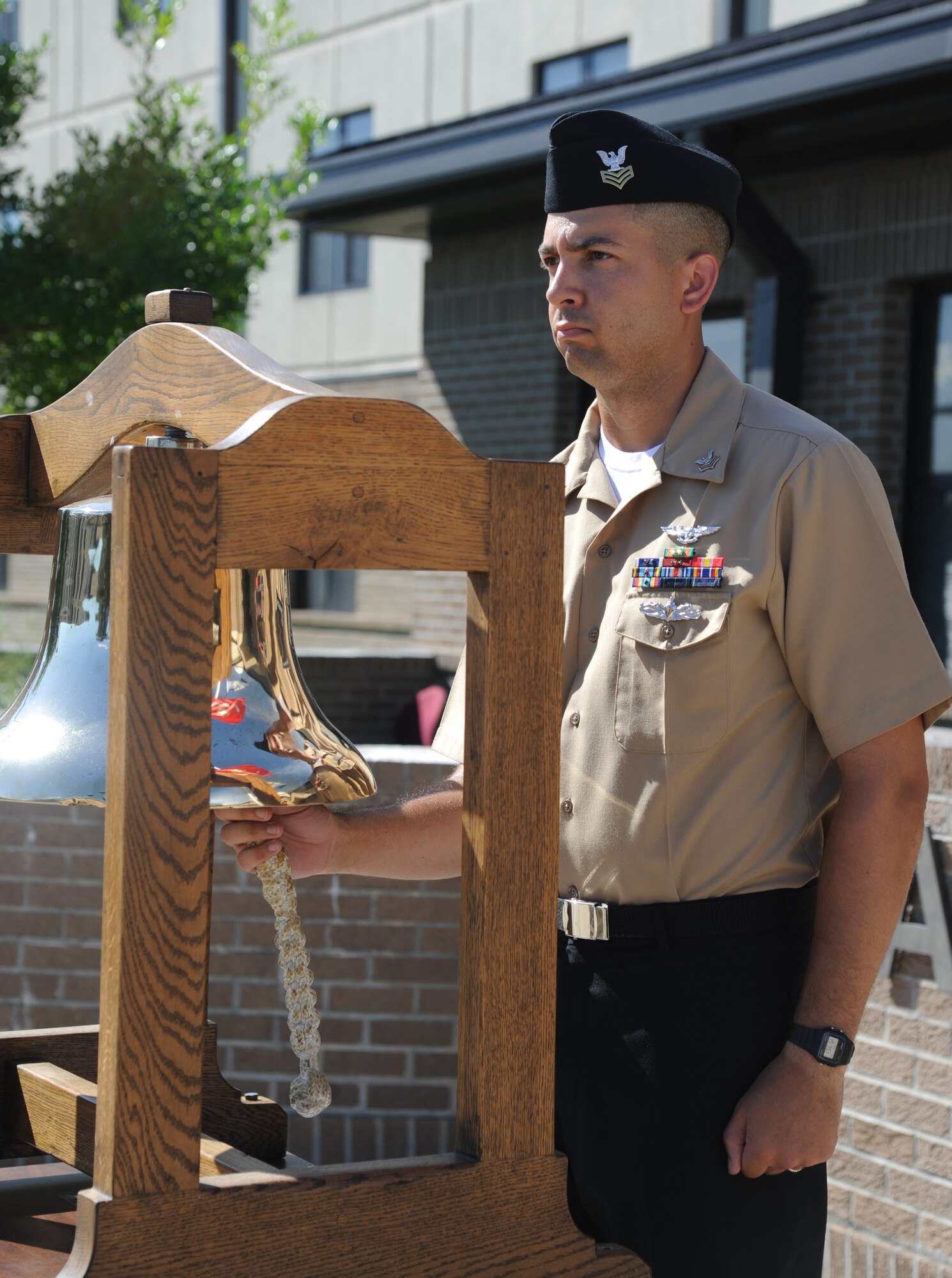 Petty Officer 1st Class Brian Draper, Center for Naval Aviation Technical Training Unit Keesler, rings a bell once for each of the sailors who lost their lives in the past 12 months while serving during a remembrance ceremony Sept. 11, 2014, Keesler Air Force Base, Miss.  The ceremony also honored those who lost their lives during the 9/11 attacks. (U.S. Air Force photo by Kemberly Groue)
