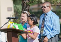 Students recite poems and read essays for the audience about the events that happened before they were born. Children from the Travis Unified School District attended the America Supports You Freedom Walk, a national tradition that calls on people to reflect on the lives lost on Sept. 11, 2001. (U.S. Air Force photo by Heide Couch)