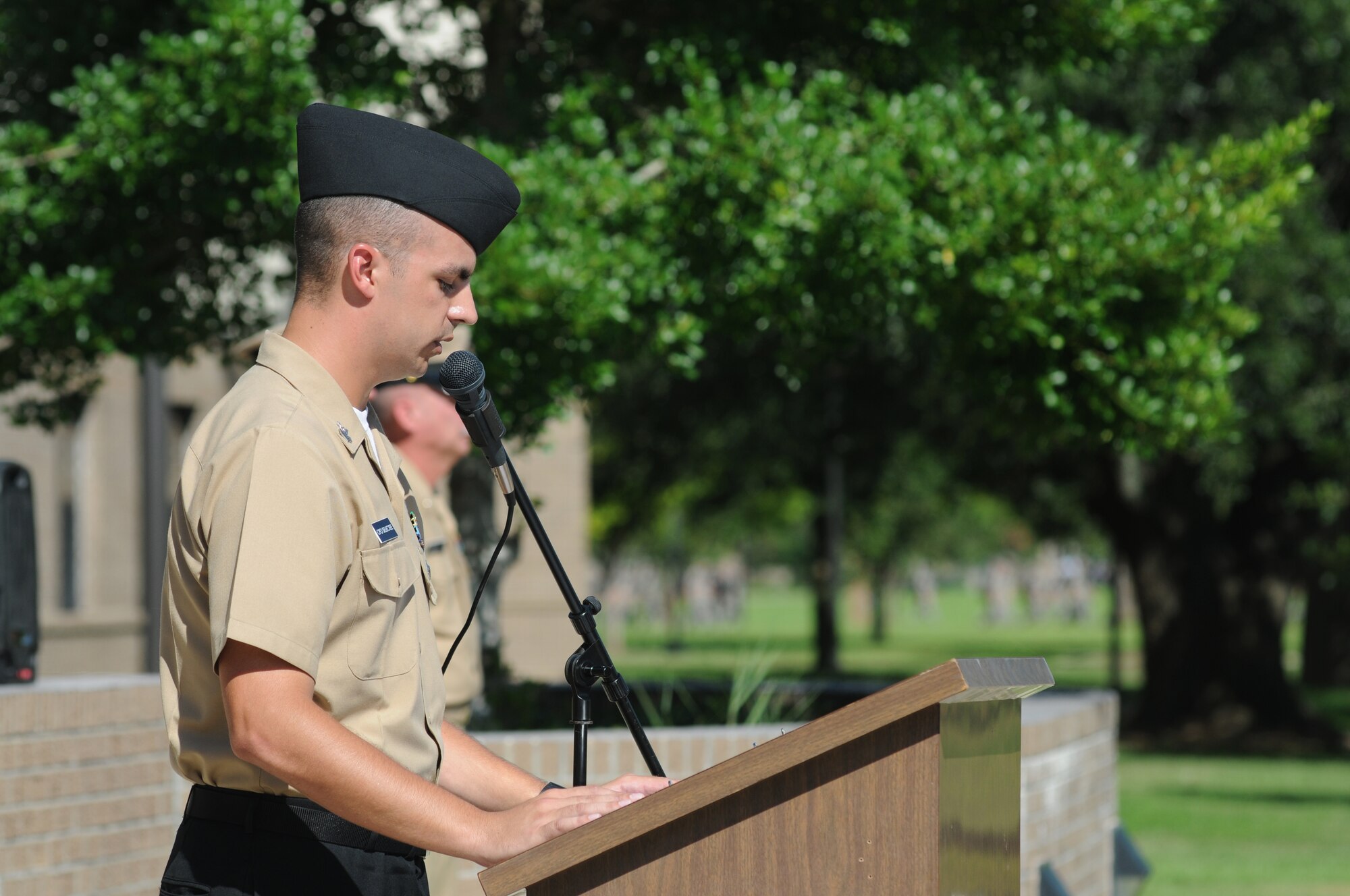 Petty Officer 1st Class Jerrod Jenkins, Center for Naval Aviation Technical Training Unit Keesler, serves as the master of ceremonies during a remembrance ceremony Sept. 11, 2014, Keesler Air Force Base, Miss. The ceremony honored those who lost their lives during the 9/11 attacks. (U.S. Air Force photo by Kemberly Groue)