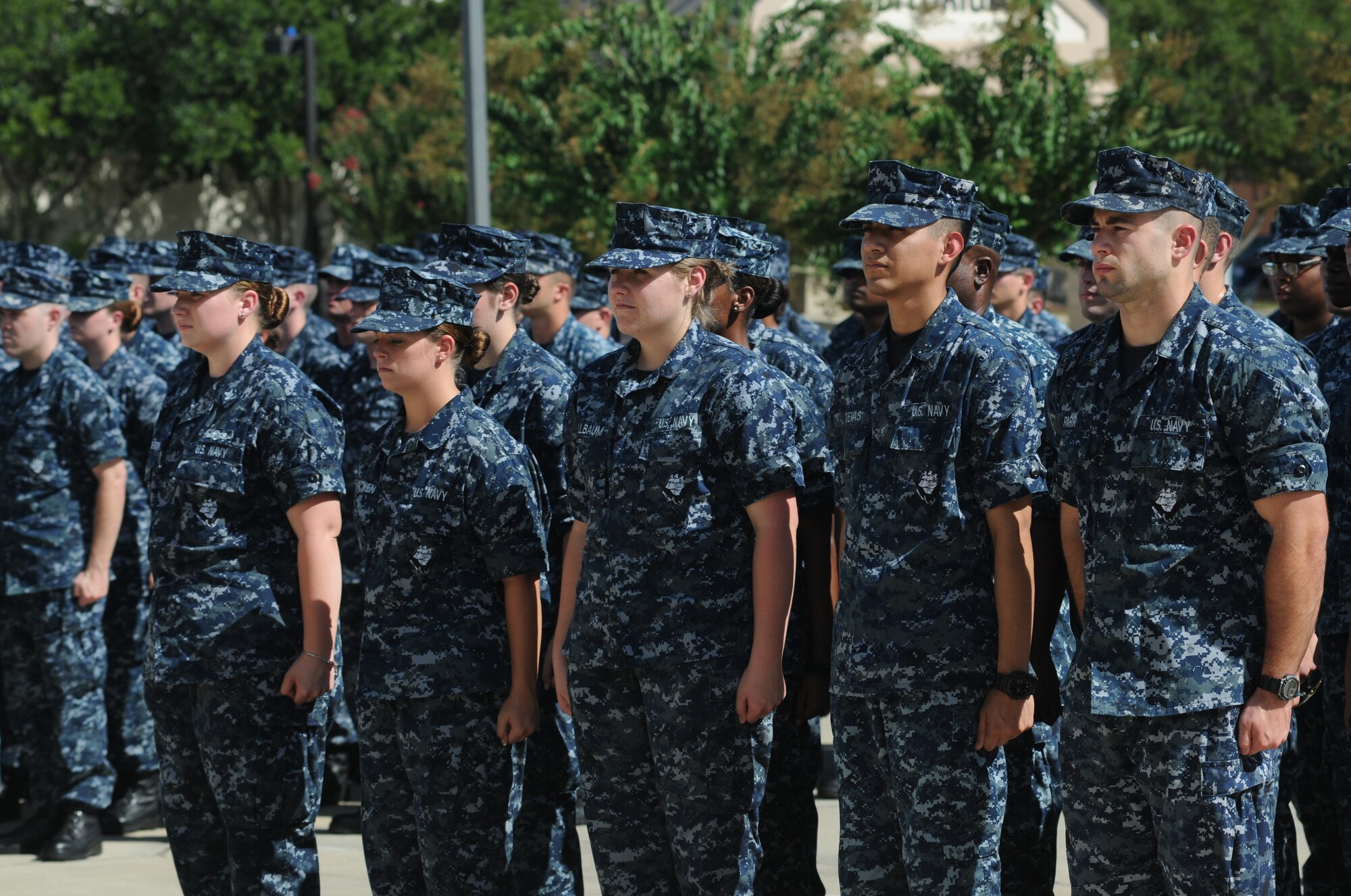 Members of the Center for Naval Aviation Technical Training Unit Keesler stand at attention during a remembrance ceremony Sept. 11, 2014, Keesler Air Force Base, Miss. The ceremony honored those who lost their lives during the 9/11 attacks. (U.S. Air Force photo by Kemberly Groue)