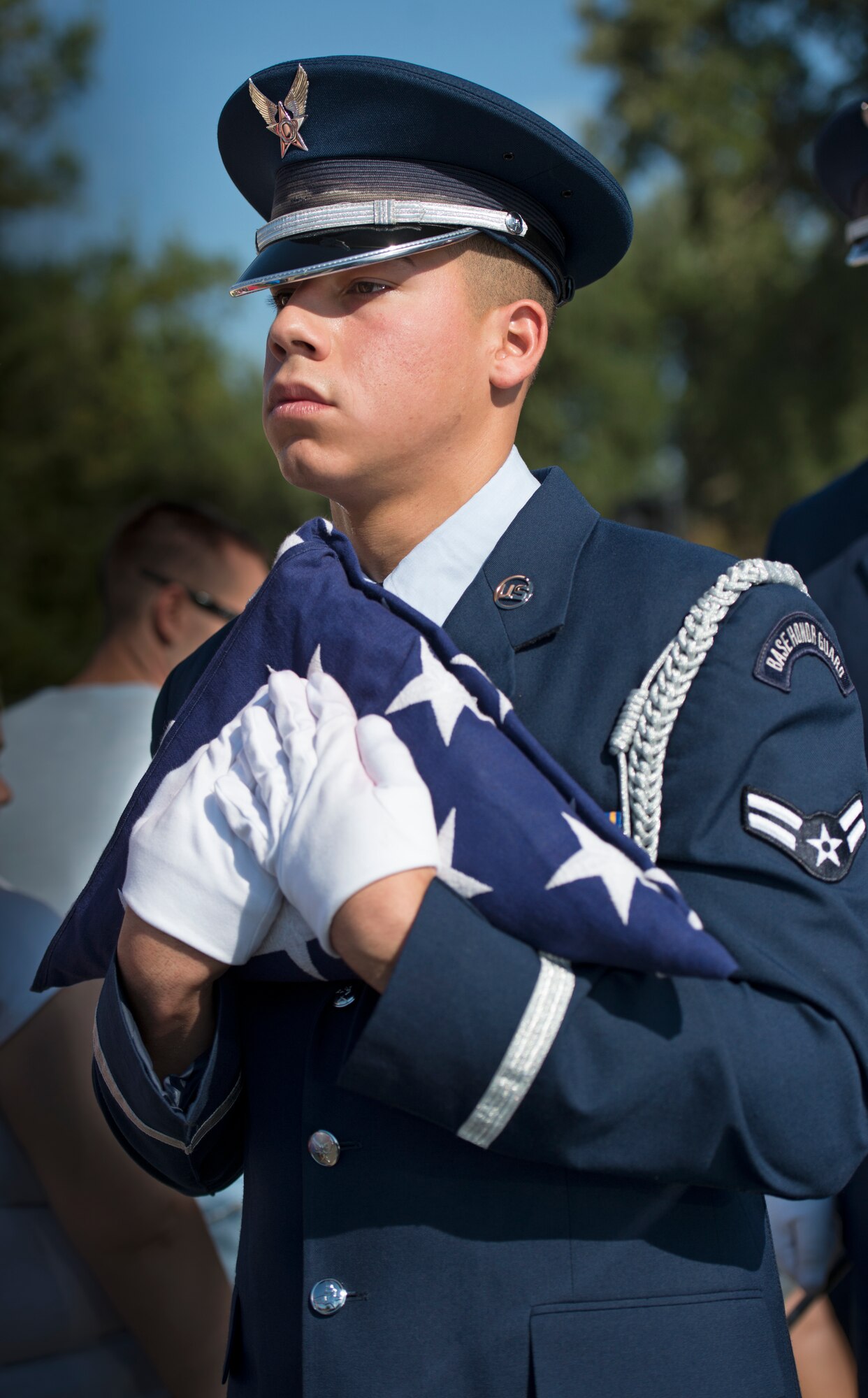 Airman 1st Class Gabriel Hurtado, 60th Aerial Port Squadron, carries a folded American Flag during a Freedom Walk Sept. 11, 2014, at Travis Air Force Base, Calif. (U.S. Air Force photo by Heide Couch)