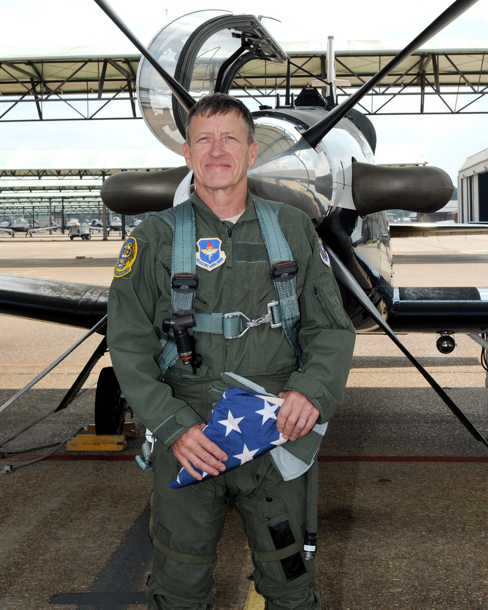 Lt. Col. Douglas Jantzen, 14th Flying Training Wing Chief of aircraft Maintenance, pauses next to a T-6 Texan II after his familiarization flight Sept. 10 on the Columbus Air Force Base flightline. The flight occurred on the 40th anniversary of Jantzen’s enlistment into the United States Air Force, making him the most senior lieutenant colonel in the U.S. Air Force. (U.S. Air Force photo/Melissa Dublin)