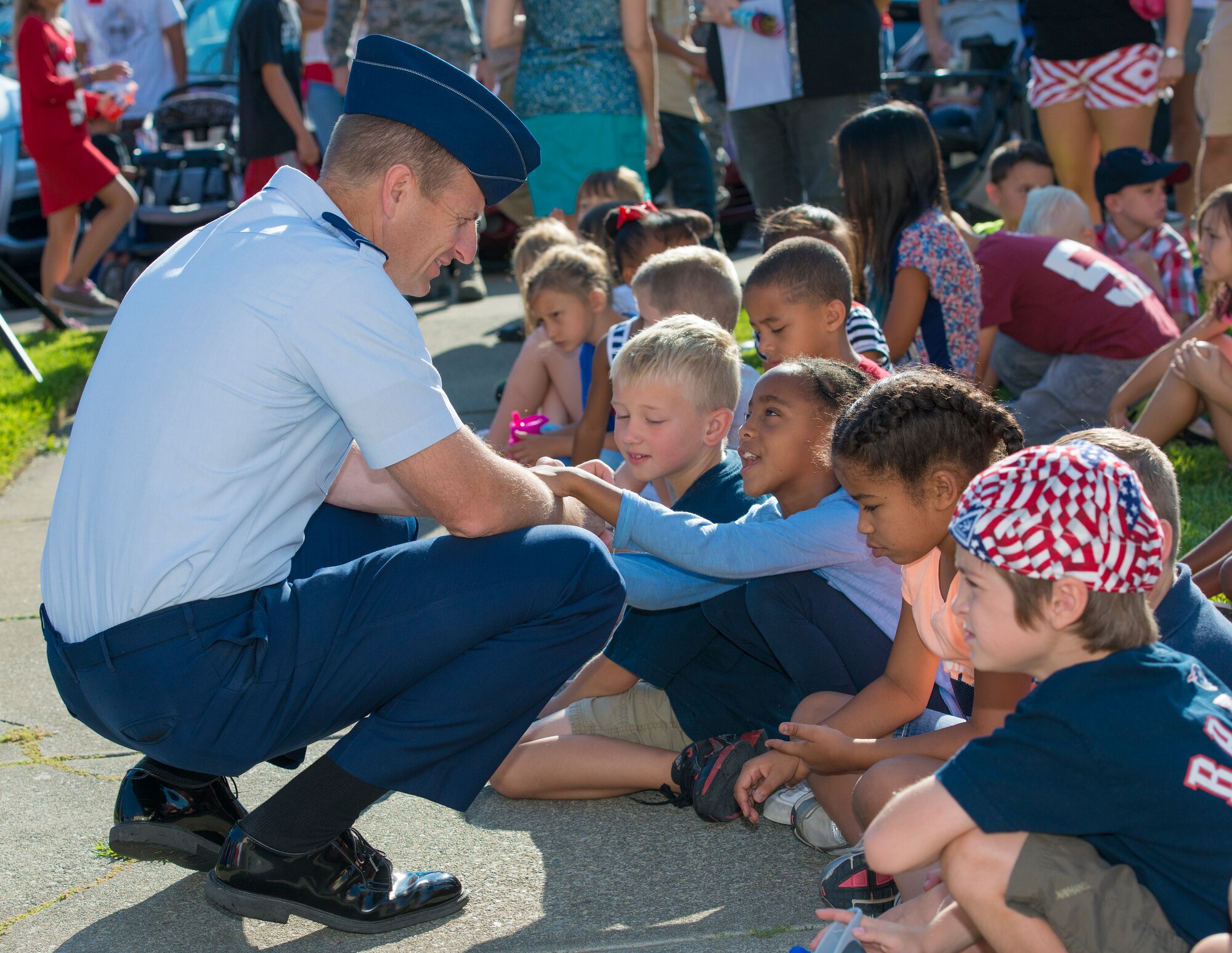 Col. Corey Martin, 60th Air Mobility Wing commander, speaks with children from the Travis Unified School District attending the Freedom Walk ceremony Sept. 11, 2014, at Travis Air Force Base, Calif. (U.S. Air Force photo by Heide Couch)