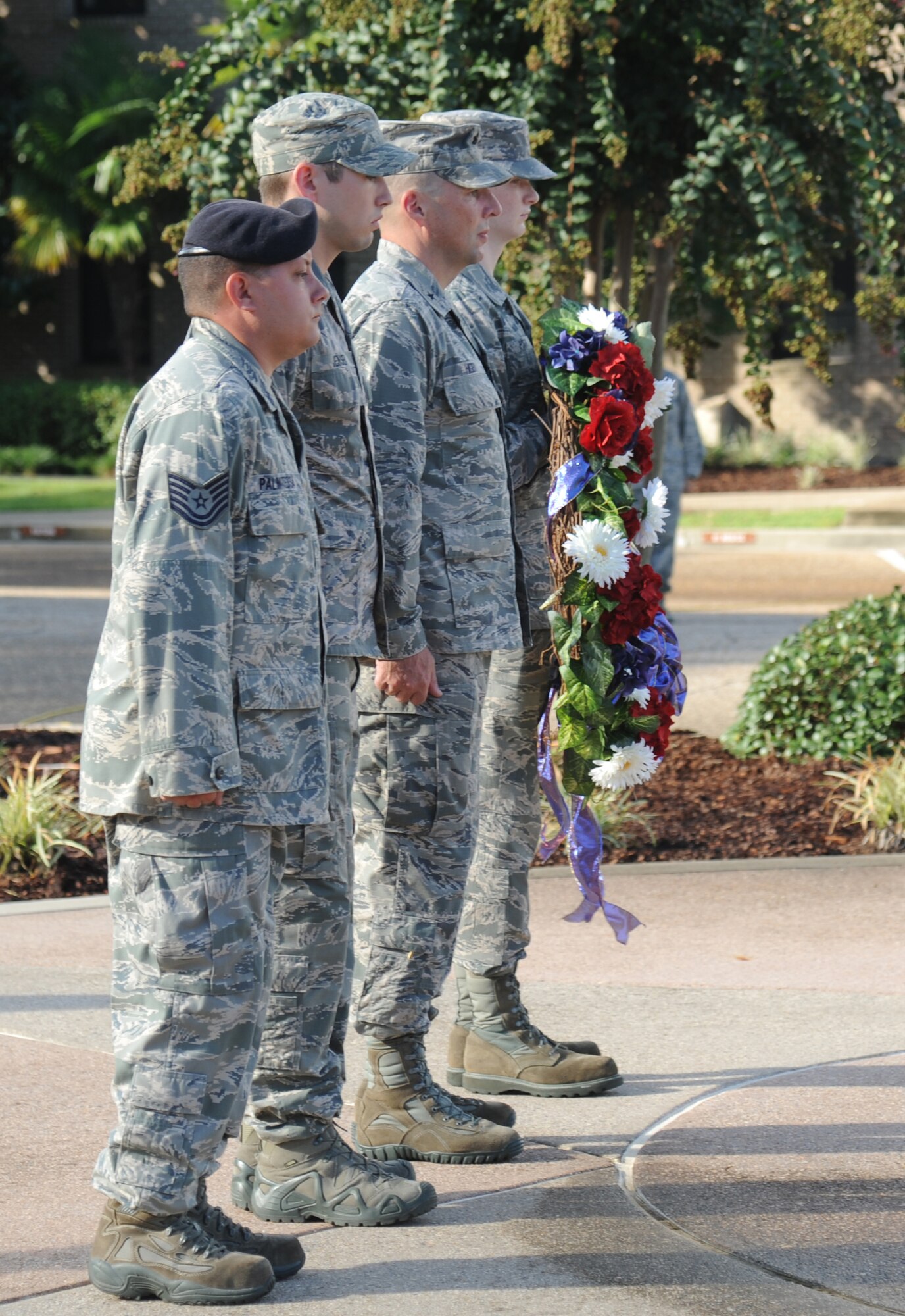 Tech. Sgt. Jason Palmitessa, 81st Security Forces; Staff Sgt. Stephen Jensen, 81st medical Operations Squadron; Brig. Gen. Patrick Higby, 81st Training Wing commander, and Airman 1st Class Codee Potts, Keesler firefighter, prepare to place a wreathe on display during a remembrance ceremony Sept. 11, 2014, Keesler Air Force Base, Miss. The ceremony honored those who lost their lives during the 9/11 attacks.  (U.S. Air Force photo by Kemberly Groue)