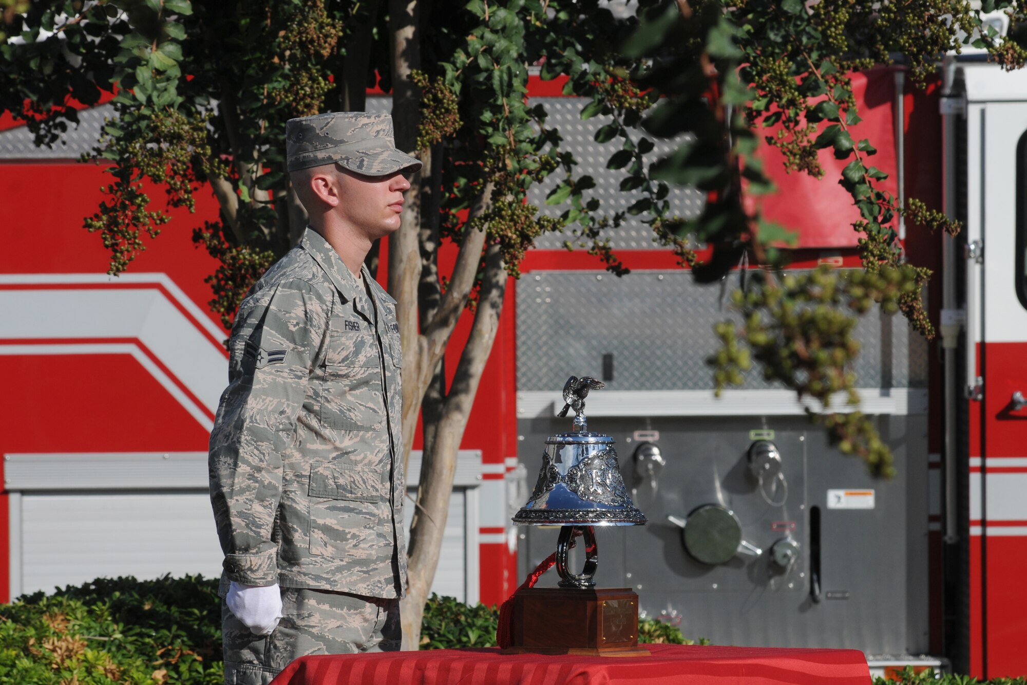 Airman 1st Class Tyler Fisher, Keesler firefighter, stands at attention in preparation to conduct a final bell tribute during a remembrance ceremony Sept. 11, 2014, Keesler Air Force Base, Miss. The ceremony honored those who lost their lives during the 9/11 attacks.  (U.S. Air Force photo by Kemberly Groue)